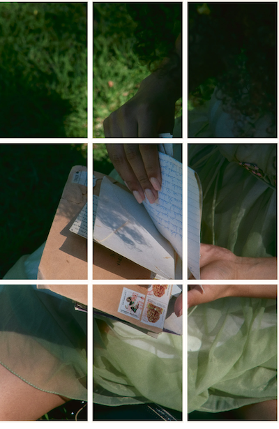 Person reading handwritten letters outdoors in the grass